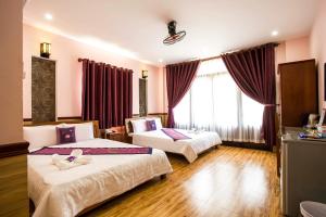 Postel nebo postele na pokoji v ubytování Hoa My II Hotel