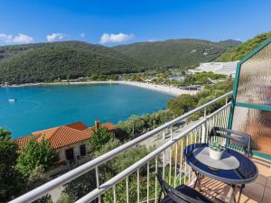 a balcony with a table and a view of a lake at Apartment Boris by Interhome in Raša