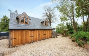 a large wooden garage with a roof at Pentland Hills Chalet in Edinburgh