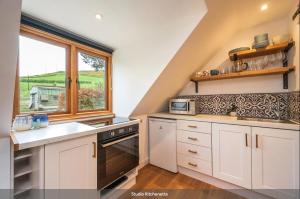 a kitchen with a sink and a window at Pentland Hills Chalet in Edinburgh