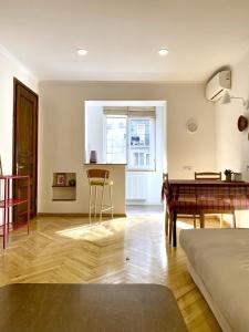 a living room with a table and a dining room at Chic 1-Bedroom appartment on Saburtalo in Tbilisi City