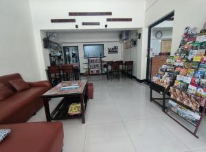a room with a couch and a table in a store at 168 Chiangmai Guesthouse in Chiang Mai +20 photos