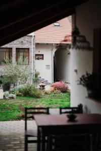an outside view of a house with a table and chairs at Apponyi Guesthouse 49 in Kaposvár