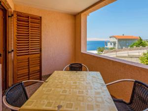 a table and chairs on a balcony with a view of the ocean at Apartment Delfin-9 by Interhome in Cesarica