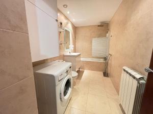 a small bathroom with a washing machine in it at Life And apartment a pie de pistas, El Tarter in El Tarter +27 photos