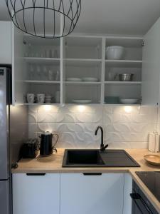 a kitchen with a sink and a counter top at Apartament nad jeziorem AN in Myślibórz +8 photos