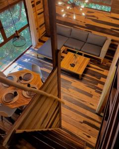 an overhead view of a living room in a log cabin at Treehouse Tulum H2Ojos in Tulum +45 photos