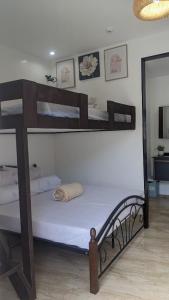 a bedroom with two bunk beds and a mirror at 102 Casa de Rany in Dumaguete