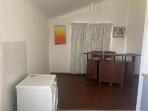 a living room with a table and a desk and aicter at Mary lodge Capetown in Cape Town