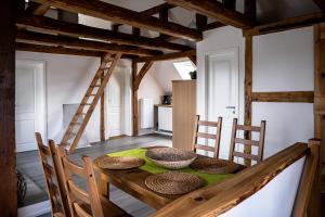 a dining room with a wooden table and chairs at Alte Schule Grambow - Lütt Slaapsteed in Grambow
