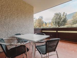 a table and chairs on a balcony with a view at Apartment Schlossalmblick by Interhome in Bad Hofgastein