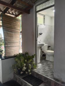 a bathroom with a toilet and a sink at Diana's place in Negombo