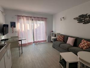 a living room with a couch and a table at Vivienda Vacacional Casa Federico in Corralejo