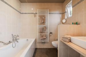 a bathroom with a tub and a toilet and a sink at Apollonia in Aalter +37 photos