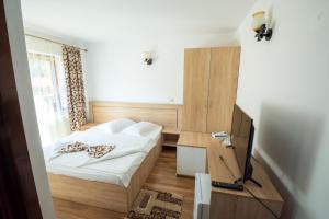 Postel nebo postele na pokoji v ubytování Cabana Dan Arieseni