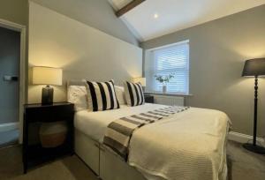 a bedroom with a large bed and a window at Queens Cottage in Skipton