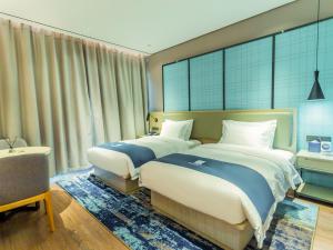 صورة لـ Echarm Hotel Qujing High-speed Railway Station Five Pavilions and One Center Branch في Qujing