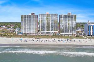 an aerial view of a beach with tall buildings at Bay Watch Resort | Oceanfront | King Suite | Budget Friendly in Myrtle Beach