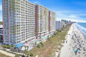 an aerial view of a beach with tall buildings at Bay Watch Resort | Oceanfront | King Suite | Budget Friendly in Myrtle Beach +8 photos
