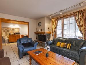 a living room with a couch and chairs and a table at Apartment La Tour d'Antheme by Interhome in Champéry
