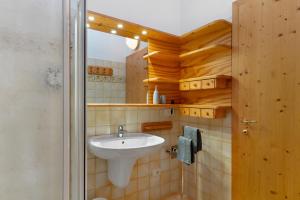 a bathroom with a sink and a mirror at Dolomiti Deluxe - Bocenago in Bocenago +30 photos