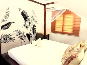 Postel nebo postele na pokoji v ubytování Nutmeg Cottage SIARGAO 2BR exclusive whole house + 31 fotografií