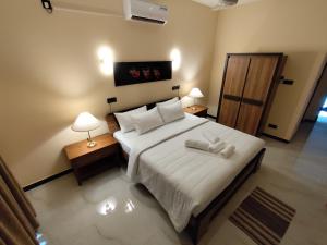 Postel nebo postele na pokoji v ubytování Villa Infinity Negombo