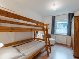 a bedroom with two bunk beds and a window at Apartment Monte Grau Top 5 by Interhome in Bad Gastein