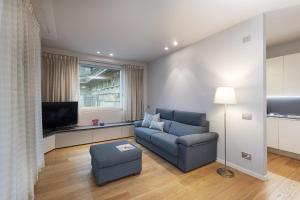 a living room with a couch and a tv at Fifty Eight Milan Duomo Two Bedrooms in Milan