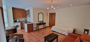 a kitchen and living room with a couch and a table at La Palma de Cabrales - AT-1501-AS in Arenas de Cabrales