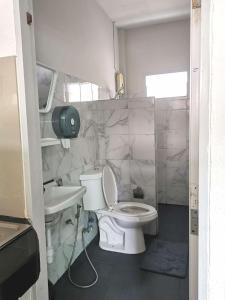 a small bathroom with a toilet and a sink at Yada House s&s in Nai Yang Beach