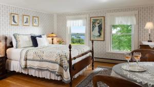 a bedroom with a bed and a table with wine glasses at Maguire House Bed and Breakfast in Ashburnham