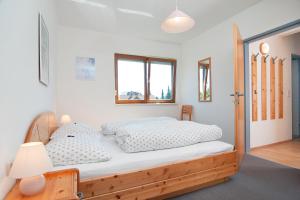 a bedroom with a bed with a wooden frame at Haus Bergblick in Faak am See