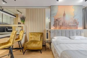 a bedroom with a bed and a desk and chairs at Manhattan High Line Apart in Kyiv