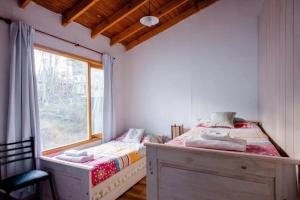 Ένα ή περισσότερα κρεβάτια σε δωμάτιο στο Cálida casa en el fin del mundo