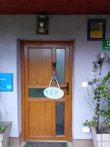 a wooden door with a sign on it at ART ROOM in Rose resort in Ljubljana