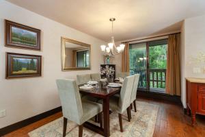 a dining room with a table and chairs at Riverfront 2 BR - Steps to Town - Pool & Hot Tub in Aspen
