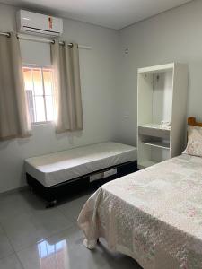 a bedroom with a bed and a window and a mattress at Casa de temporadas Simone/ Rafael in Carolina