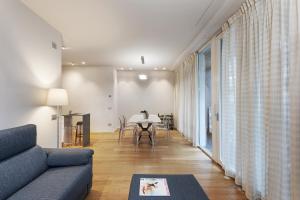 a living room with a couch and a table at Fifty Eight Milan Duomo in Milan
