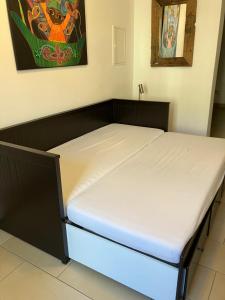 a bed in a room with a white mattress at Studio Apartment im Palais Fleur Blanche in Potsdam