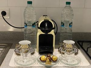 a coffee maker sitting on a counter with two water bottles at Studio Meuble a 5 min de l'aéroport Casablanca in Nouaceur +11 photos