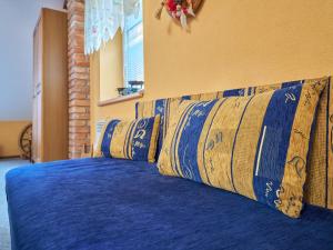 a bed with blue sheets and pillows on it at Studio Chlívce u Hronova-2 by Interhome in Chlívce +39 photos