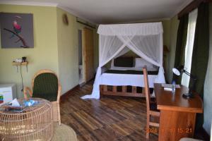 a bedroom with a bed with a canopy at Mwi Village House in Mto wa Mbu