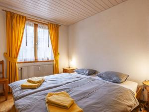 a bedroom with a large bed with towels on it at Apartment La Tour d'Antheme by Interhome in Champéry