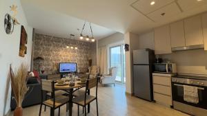 a kitchen and living room with a table in a room at Rodeo Retreat - Chic 1BR Apartment on Yas Island, 12 Min to Grand Prix in Abu Dhabi