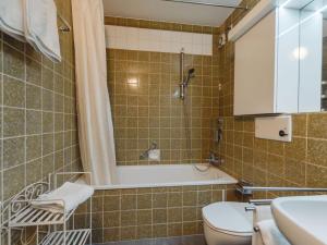 a bathroom with a shower and a toilet and a sink at Apartment Schlossalmblick by Interhome in Bad Hofgastein