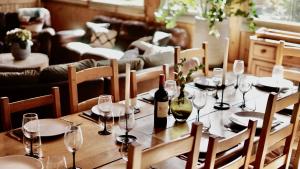 a wooden table with wine bottles and glasses on it at Chalet Sosa in Morzine