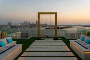 a rooftop deck with a view of the city at C Central Hotel and Resort The Palm in Dubai