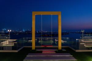a building with a view of the city at night at C Central Hotel and Resort The Palm in Dubai