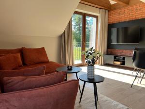 a living room with a couch and a tv at Apartamenty Spacerowa 33 in Wisła